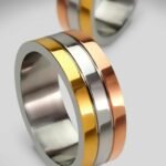Elegant tri-color gold rings showcasing modern design, perfect for engagements or weddings.
